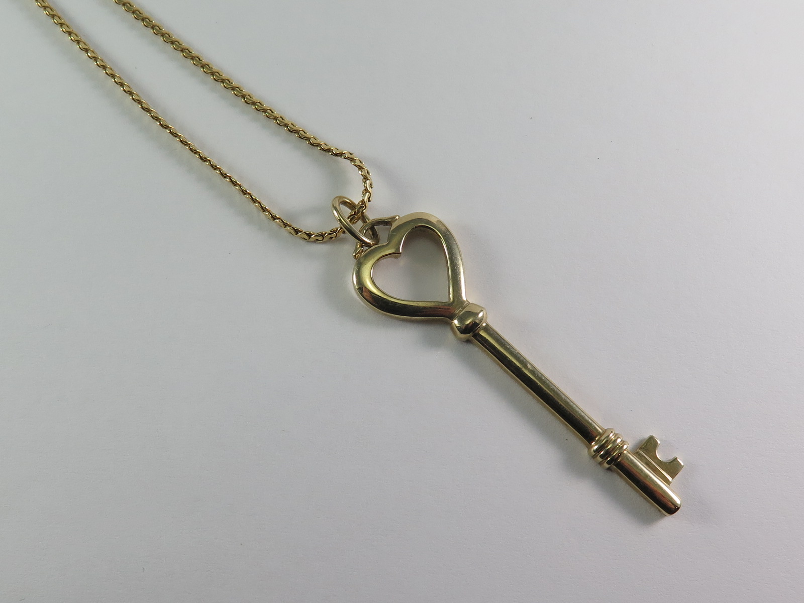 A 9ct Gold Key Pendant And Chain - ABA Associates | Find Lots Online